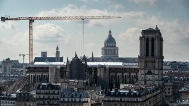 This general view taken in Paris on March 9, 2022 shows Notre-Dame de Paris Cathedral and the Pantheon in the background, seen from a rooftop.