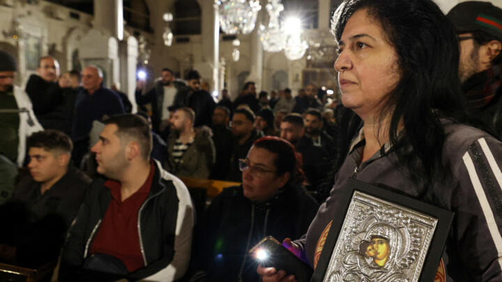 Christian worshippers stage a demonstration in the Mariamite Church in Damascus early on December 24, 2024.