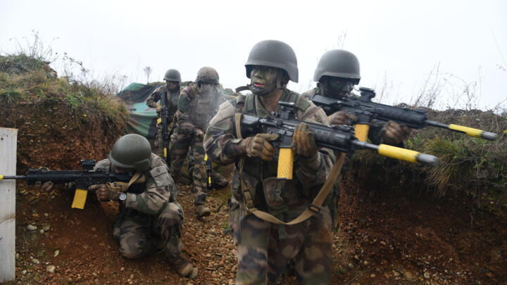 Young recruits from the Régiment de Marche du Tchad take part in a drill in the trenches set up for the purpose at their camp in Alsace, on 17 December 2024.