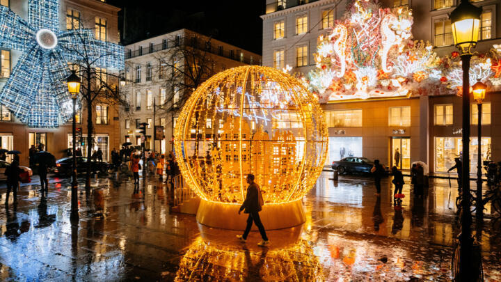 A pedestrian walks past Christmas lights on the rue du Faubourg-Saint-Honoré in Paris on November 27, 2024.