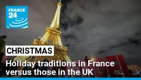 Visitors walk past letters reading Noel (Christmas) in front of the Eiffel Tower on December 23, 2023 in Paris.